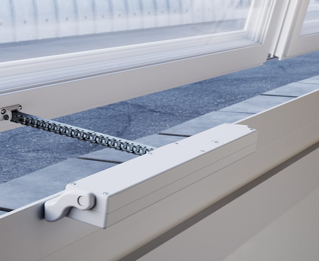 Close-up of a Comunello Mowin automated window system installed on a top-hung window frame.